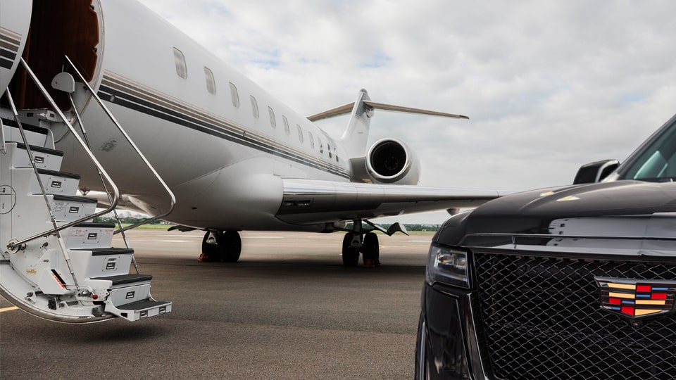 chauffeur greeting Teterboro airport car service client at FBO ramp